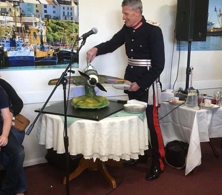 HM Lord-Lieutenant of Devon cuts commemorative spitfire cake for 75 year since D Day at Brixham